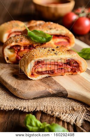 Stromboli Stuffed With Cheese, Salami, Green Onion And Tomato Sauce