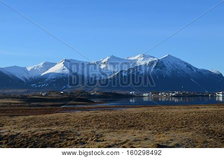 Harbor town at the base of the Rhyolite Mountains in Iceland.