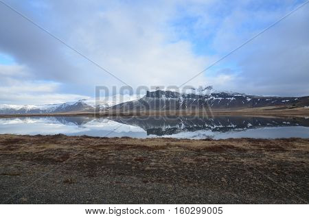 Mountains reflecting in the water in gorgeous Iceland.