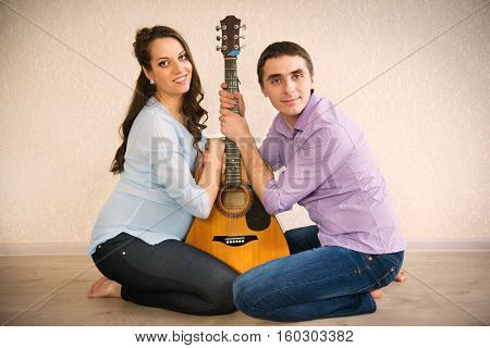 Happy young couple anticipating childs birth at home