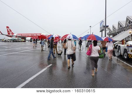 Kuala Lumpur,Malaysia 7th,November,2016 passenger with umbrella walking to the airport lobby at Langkawi Malaysia during raining day