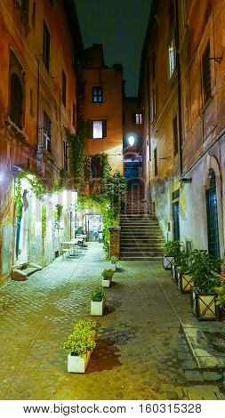 Narrow lane in the historic district of the ancient city of Rome by night