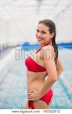 Pretty girl in fancy bikni around pool side.
