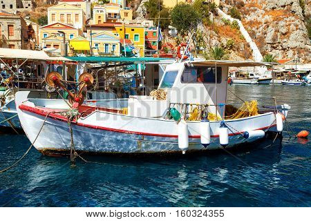 Symi island - Colorful houses and small boats at heart of the village