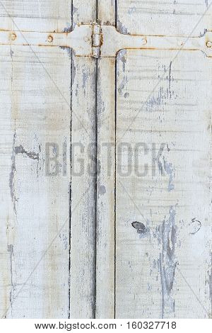 Old door from darkened boards with archaic iron plates