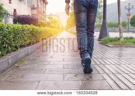 Man Jeans And Sneaker Shoes Walking On Footpath