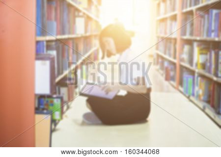 Blurred of Asian student in uniform reading in the library at university and Research Knowlege