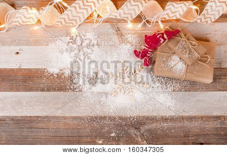 Christmas background with gift boxes and christmas ornaments on wooden board