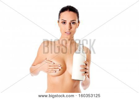 Nude woman is holding a ewer of milk. Spa concept.