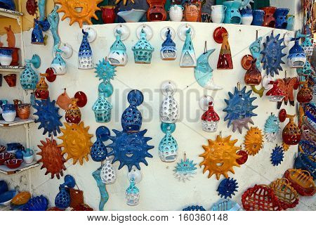 MARGARITES, CRETE - SEPTEMBER 15, 2016 - Pottery displayed on the wall of a shop in the village centre Margarites Crete Greece Europe, September 15, 2016.