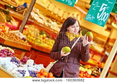 Young Woman Buying Fresh Fruits At Market