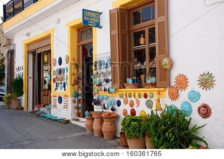 MARGARITES, CRETE - SEPTEMBER 15, 2016 - Pottery displayed on the wall of a shop in the village centre Margarites Crete Greece Europe, September 15, 2016.