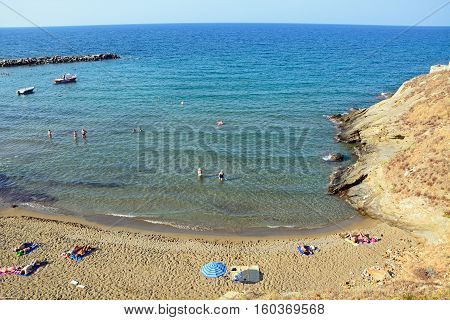 PANORMOS, CRETE - SEPTEMBER 15, 2016 - Elevated view of tourists relaxing on the sandy beach Panormos Crete Greece Europe, September 15, 2016.
