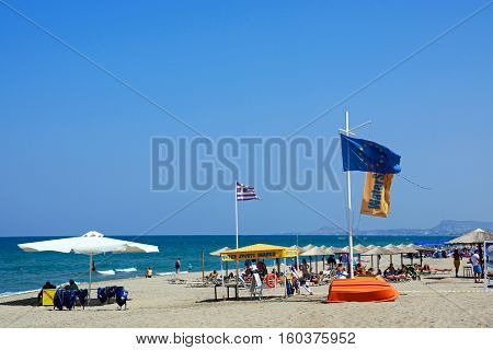 PERIVOLIA, CRETE - SEPTEMBER 15, 2016 - Tourists relaxing on the sandy beach Perivolia Crete Greece Europe, September 15, 2016.