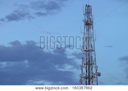 Telecommunication tower with antennas communication telecom radio telephone mobile phone in evening sky