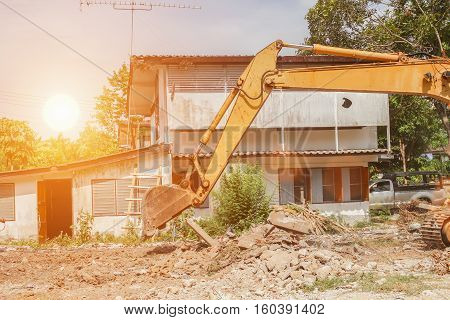 bucket excavator destruction in work outdoor construction with sunset light tone