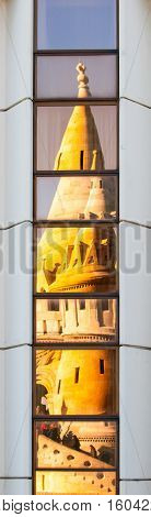 Detailed view of warped reflection of Fisherman's Bastion, aka Halaszbastya, fairy tale towers in windows of modern hotel. Architectural constrast of historical landmark and hated modern architecture of communistic Hungary. Budapest, capital city of Hunga
