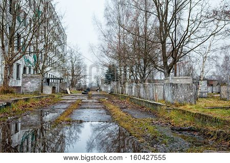 old abandoned high-rise building on gloomy cold autumn day