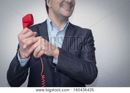 Young businessman with the phone satisfied-happy. The Boss informs him that he did a good job