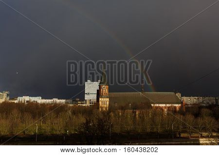 Kaliningrad Russia - December 06 2016: The rainbow over the Cathedral on the background of a stormy sky