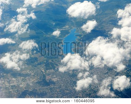 panoramic view of mountains and lake out of plane's window