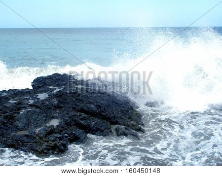 Lovely ocean with wave breaking on rocks