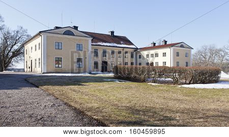 UPLAND, SWEDEN ON APRIL 11. View of a garden, park and a main building on April 11, 2013 in Upland, Sweden. Sunny and chilly morning. Editorial use.