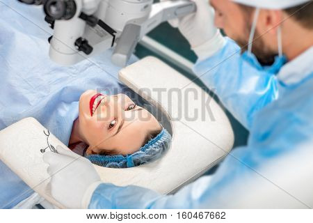 Happy patient speaking with surgeon lying on the couch before the operation in the operating room