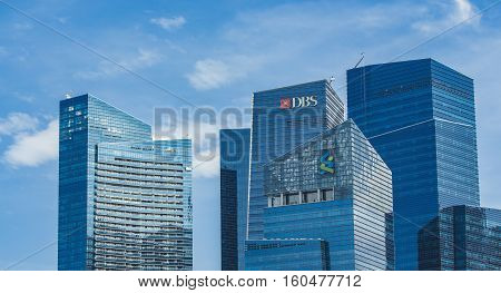 SINGAPORE - AUGUST 6, 2014: Modern skyscrapers at Marina Bay Financial Centre in Singapore. Marina Bay Financial Centre was design by Kohn Pedersen Fox and was opened at 2013.