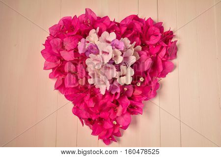 Bougainvillea heart on wood background, valentine day.