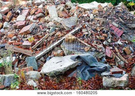 A heap of construction and demolition debris garbage bricks and material of an old house.