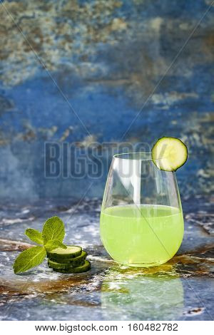 Sparkling cucumber mint gin and tonic fizz with aloe vera on marble table. Copy space