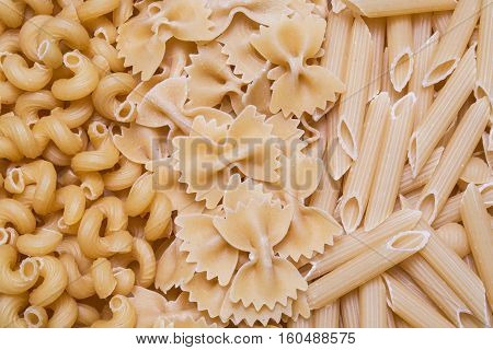 horns feathers bows pasta or macaroni background texture