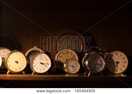 vintage clocks on wooden table in 2 rows