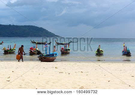 RAWAI BEACH PHUKET ISLAND THAILAND - FEBRUARY 28 2016: long tailed boat at exotic Bay of Rawai in Phuket island Thailand