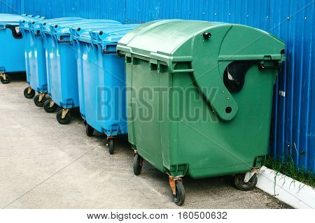 many garbage containers stand in a row. Ecological concept.