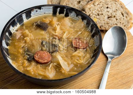 Christmas cabbage soup with mushrooms on natural background.