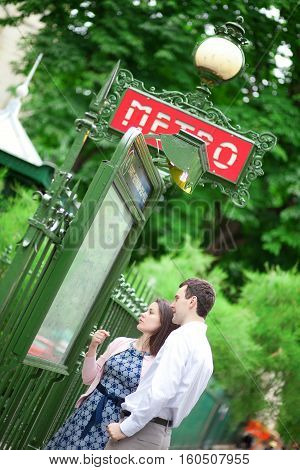 Beautiful Couple Is Looking At The Metro Plan