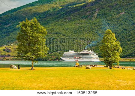 Tourism vacation and travel. Mountains landscape and big cruise ship on fjord Sognefjord in Flam Norway Scandinavia.