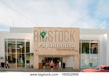 PAPHOS CYPRUS - OCT 28 2014: Papatoniu supermarket chain in Cyprus on a sunny day with people entering to buy food and non-food products. Papatoniu is the leading supermarket in Cyprus