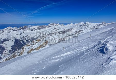 View from Mt. Titlis in Switzerland in winter. Titlis is a mountain, located on the border between the Swiss Cantons of Obwalden and Bern.