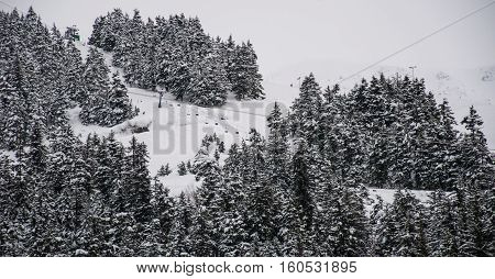 Ski Lift riding up the side of a Alaska Snow Covered Mountain. Girdwood , Alaska , USA at Alyeska Ski Resort on a Powder Snow Winter Wonderland ski day