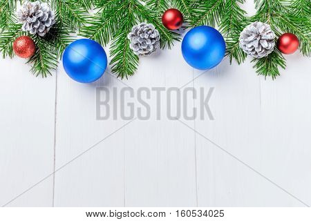 Christmas New Year composition with tangerines, cones, nuts, wicker basket and fir branches in rustic style on old wooden background, selective focus, Background new year, fir, gift, cones, orange, blue ball, red background, snow, ,