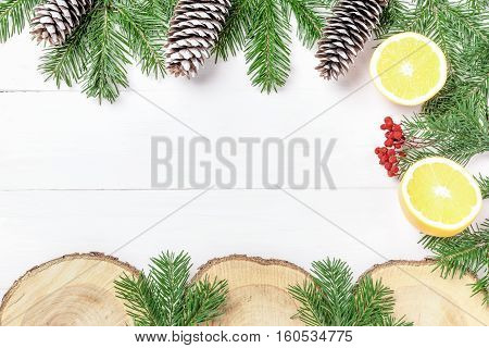 Christmas New Year composition with tangerines, cones, nuts, wicker basket and fir branches in rustic style on old wooden background, selective focus, Background new year, fir, gift, cones, orange, blue ball, red background, snow, ,
