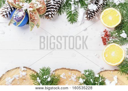 Christmas New Year composition with tangerines, cones, nuts, wicker basket and fir branches in rustic style on old wooden background, selective focus, Background new year, fir, gift, cones, orange, blue ball, red background, snow, ,