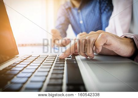 Team work process. young business managers crew working with new startup project. labtop on wood table typing keyboard texting message analyze graph plans