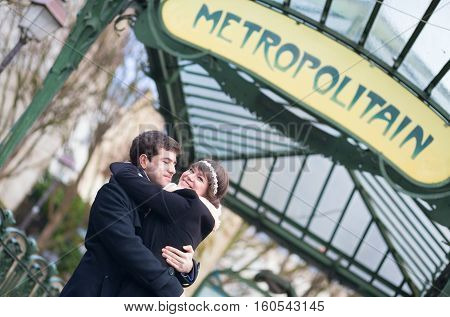 Happy Couple Under The Metro Sign In Paris