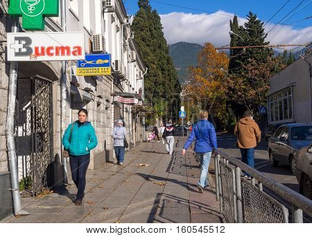 Yalta, Russia - November 13, 2015: People flow along Sadovaya street of Yalta