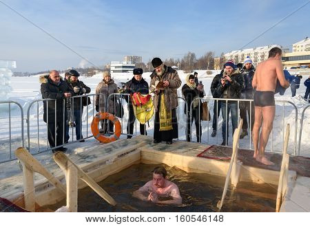 Priest Consecrates The Ice Hole On Epiphany Day. Russia