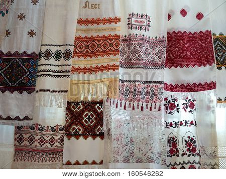 Many Ukrainian national towels with embroidered hanging on a rope